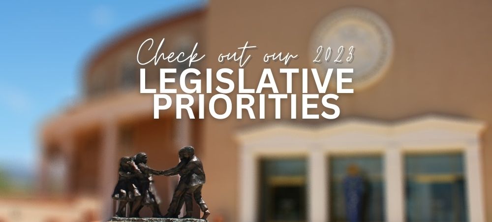 NM state capitol building roundhouse white text "check out our 2023 legislative priorities"